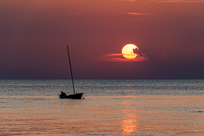 Sunset And Fisherman